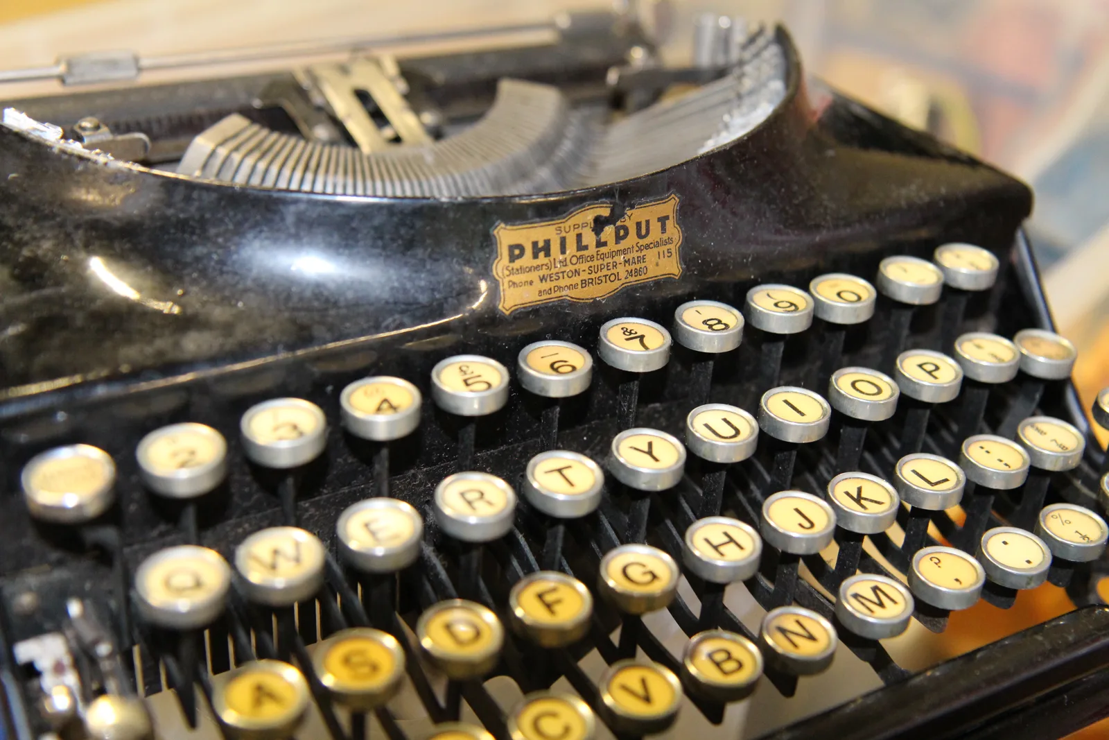 Close-up of the round glass keys of an old typewriter, one of the parts gathered for the build.