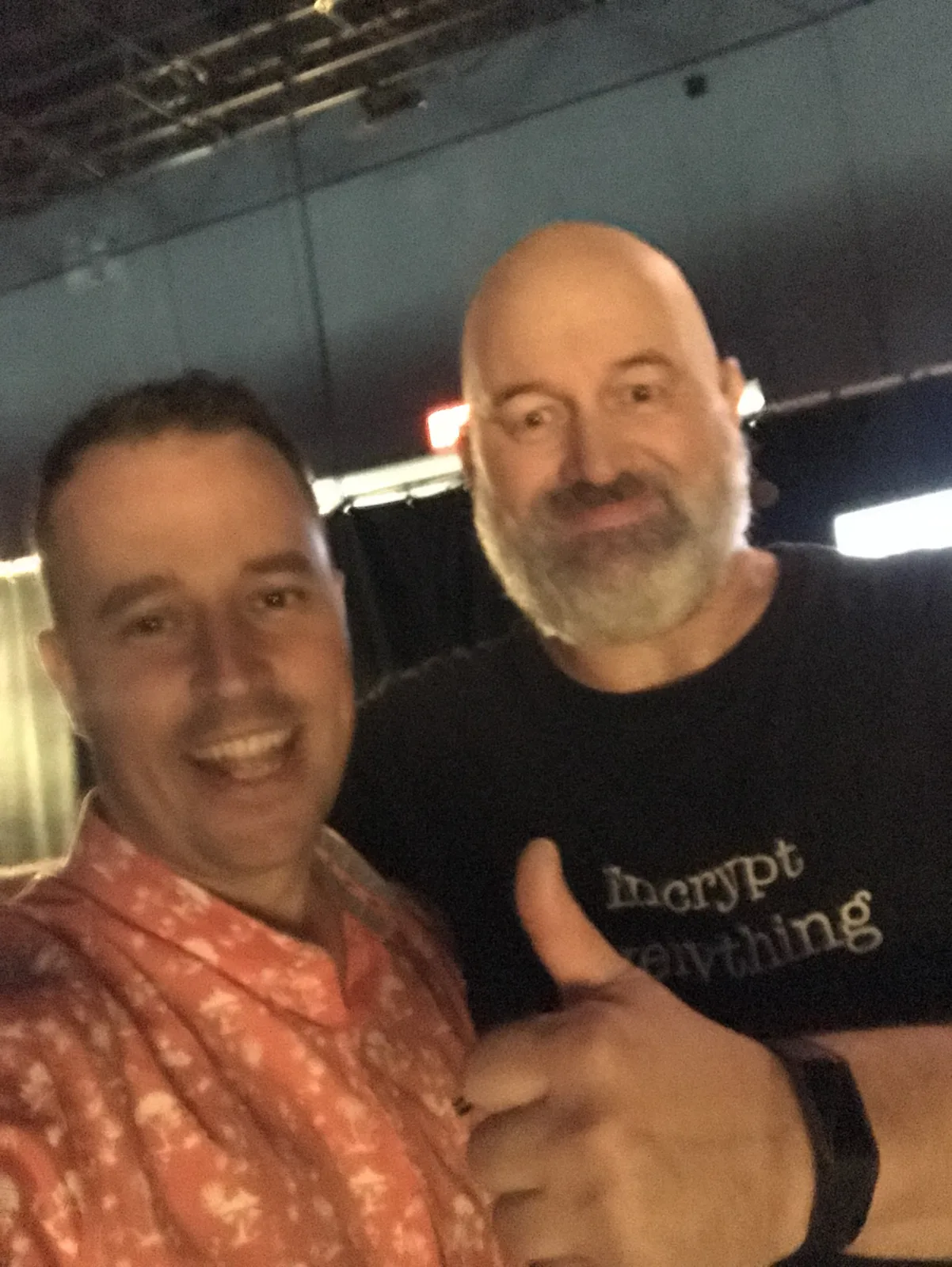 A backstage selfie of Martin with Dr. Werner Vogels, who is giving a thumbs up in an “Encrypt everything” T-shirt.