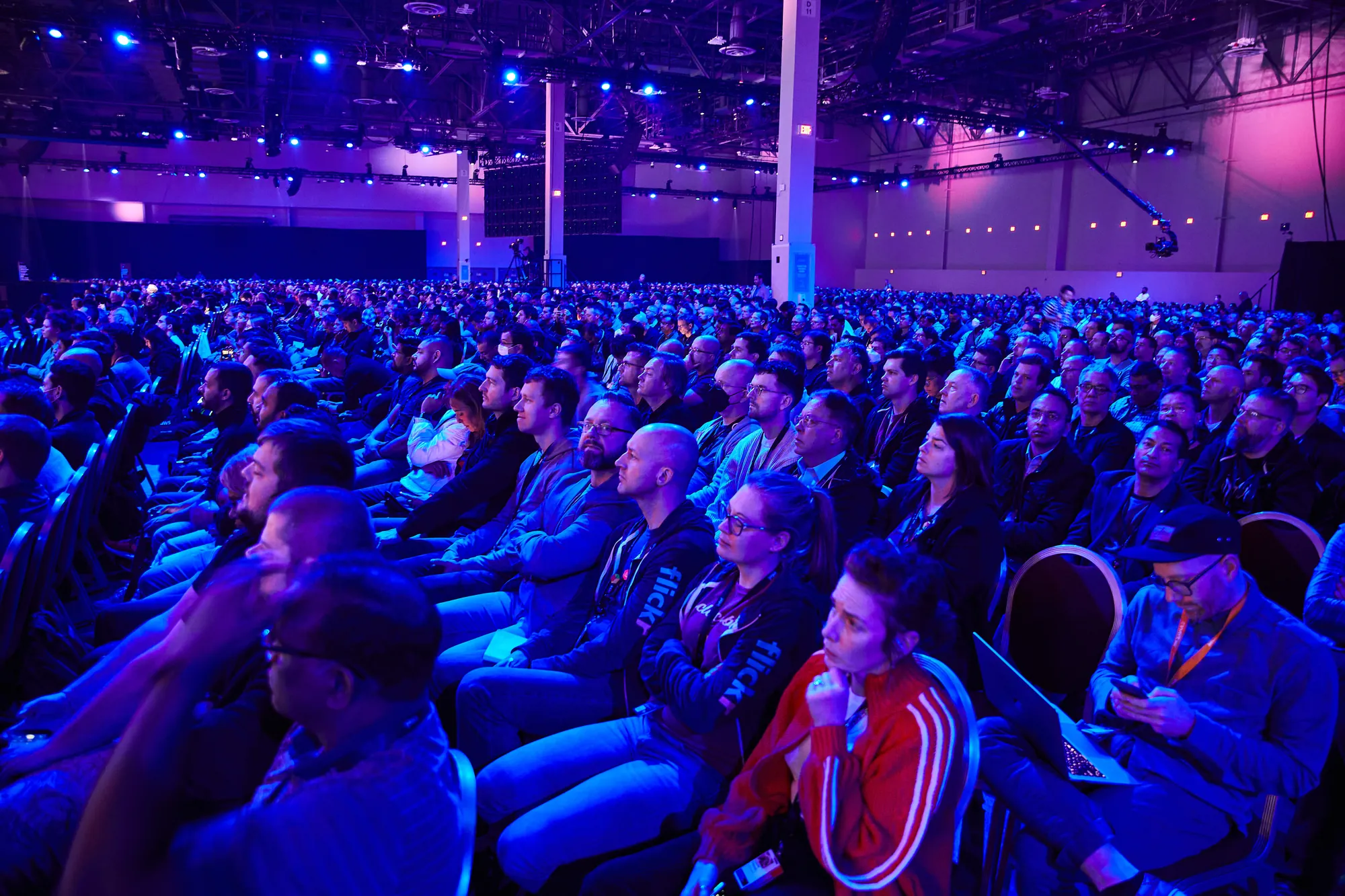 The audience, lit blue, watching the keynote